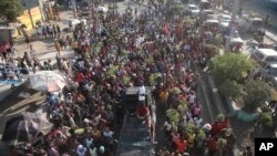 FILE - Factory workers march to demand salary increases in Port-au-Prince, Haiti, May 9, 2023.