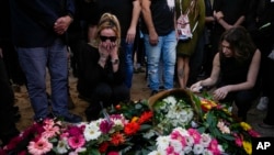 Mourners gather in grief during the funeral of Shani Gabay in the northern Israeli town of Yokneam, Nov. 23, 2023.