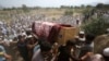 FILE - Relatives and mourners carry the casket of a victim, who was killed in a suicide bomber attack in the Bajaur district of Khyber Pakhtunkhwa, Pakistan, July 31, 2023.