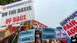 People protest outside of the Supreme Court in Washington, June 29, 2023. 