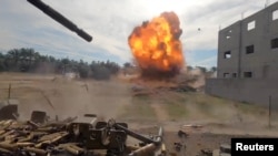Debris scatters amidst an explosion during what the Israeli army says was an operation in Khan Younis, in the southern Gaza Strip, in this screengrab taken from a video released by Israeli Defense Forces on Dec. 8, 2023.