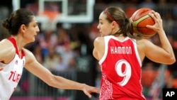 FILE - Russia's Becky Hammon, right, looks to pass against Turkey's Nevriye Yilmaz during a women's basketball game at the 2012 Summer Olympics, in London, Aug. 7, 2012.