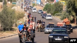 Palestinians with their belongings leave Gaza City as they flee from their homes following the Israeli army's warning, Oct. 13, 2023. 