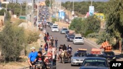 Palestinians with their belongings leave Gaza City as they flee from their homes following the Israeli army's warning, Oct. 13, 2023.