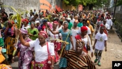 FILE - Catholic faithful march carrying palm fronds to commemorate Palm Sunday, which marks the entry of Jesus Christ into Jerusalem, on the streets of Lagos, Nigeria, April 2, 2023.