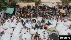 FILE — People fleeing gang violence take shelter at a sports arena in Port-au-Prince, Haiti, Sept. 1, 2023. 