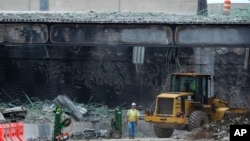 Crews continue to work the scene of a collapsed elevated section of Interstate 95 in Philadelphia, June 14, 2023. 