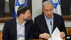 FILE - Israeli Prime Minister Benjamin Netanyahu, right, speaks with Minister of Finance Bezalel Smotrich during the weekly cabinet meeting at the Defense Ministry in Tel Aviv, Israel, Jan. 7, 2024.