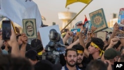 Iraqis raise copies of the Quran, Muslims' holy book, during a protest in Tahrir Square, July 20, 2023 in Baghdad, Iraq. 