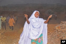 A woman cries as she calls out to the government to help rescue students that were kidnapped by gunmen in Chikun, Nigeria, March 7, 2024.
