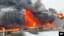 In this photo taken from video released by Governor of Bryansk Region Alexander Bogomaz telegram channel AV BogomaZ on Friday, Jan. 19, 2024, Oil reservoirs are seen in fire after the drone reached Klintsy. 