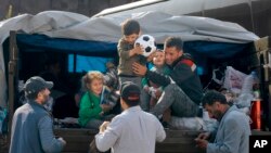 An ethnic Armenian family from Nagorno-Karabakh arrive in Armenia's Goris in Syunik region, Armenia, Sept. 30, 2023. Armenian officials say that by Friday evening, more than 100,000 of Nagorno-Karabakh's 120,000 residents had left the region.