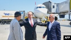 Austrian foreign minister Alexander Schallenberg, center, welcomes Kamran Ghaderi, right, and Massud Mossaheb June 3, 2023, at the Vienna airport. (Photo by Karl Schober / Austrian Interior Ministry / AFP)