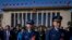 Military officers and delegates leave the Great Hall of the People after attending the second plenary session of the National People's Congress (NPC) in Beijing, March 8, 2024.