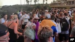 Tourists being evacuated during a forest fire on the island of Rhodes, Greece, July 22, 2023. Four locations on the island of Rhodes, including two seaside resorts, were evacuated.