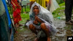 A woman whose family members are trapped under rubble wails after a landslide washed away houses in Raigad district, western Maharashtra state, India, July 20, 2023. 