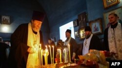 A church service is held for those killed in the Russian Il-76 military transport plane crash in the Belgorod region, in the village of Yablonovo near the crash site, on Jan. 24, 2024.