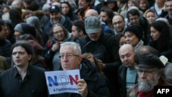 Protesters holding a placard which reads as 'No to antisemistism' participate in a march against anti-Semitism in Paris, Nov. 12, 2023.