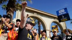 SAG-AFTRA chief negotiator Duncan Crabtree-Ireland, left, rallies striking actors in outside Paramount Pictures studio, Nov. 3, 2023, in Los Angeles. 
