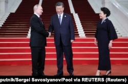 Presiden Rusia Vladimir Putin disambut oleh Presiden China Xi Jinping dan istrinya Peng Liyuan di Beijing, China, 17 Oktober 2023. (Foto: Sputnik/Sergei Savostyanov/Pool via REUTERS)