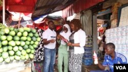 Tech entrepreneur Tomi Ayorinde of MobileForms, and three of his colleagues, visit a market in the Nigerian capital of Abuja to poll vendors on the price of their goods.