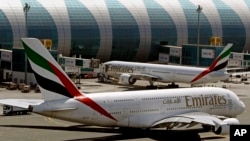 FILE - Emirates passenger planes are seen at Dubai airport in United Arab Emirates, May 8, 2014. 