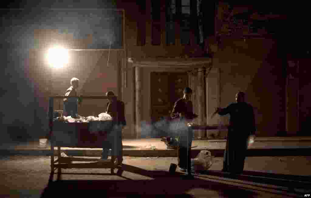 A father and son cook kebabs for residents in the city of Deir Ezzor on March 4, 2013. Once a thriving hub of Syria's oil industry, Deir Ezzor is now a ghost town of only a few thousand people.