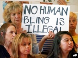 Vicky Chavez, lower left, stands with supporters during a news conference at the First Unitarian Church in Salt Lake City, July 9, 2018.