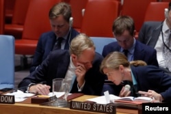 British Ambassador to the United Nations Matthew Rycroft speaks with U.S. Ambassador to the United Nations Samantha Power during a high level meeting on Syria by the United Nations Security Council at the United Nations in Manhattan, New York, Sept. 25, 2
