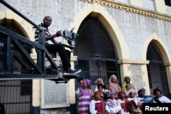 FILE - A cameraman films a scene from a crane during the making of "Ake," a film based on the childhood memoirs of Nigerian writer Wole Soyinka, in Abeokuta, southwest Nigeria, July 14, 2013. Nigeria's movie business, often known as Nollywood, is one of the biggest in the world.