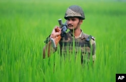 An Indian Border Security Force soldier patrols the India-Pakistan border area at Ranbir Singh Pura, about 35 kilometers (22 miles) from Jammu, India, Sept. 24, 2016.
