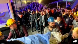 15일 터키 아마스라 탄광 근무자들이 전날 발생한 폭발 사고의 희생자를 옮기고 있다. 