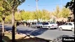 Protesters donning black march down the street following the death of Mahsa Amini in Saqez in Kurdistan Province, Iran October 4, 2022 in this screengrab obtained by Reuters from a social media video.