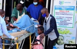 Students injured when fire gutted down a dormitory building at the Salama School for the Blind, are received for treatment at the Herona Hospital in Kisoga Town, near Kampala, Uganda, Oct. 25, 2022.