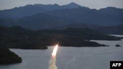FILE - This undated photo released from the Korean Central News Agency on Oct. 10, 2022, shows a missile launch training by the Korean People's Army Tactical Nuclear Operation Unit from an undisclosed area. On Tuesday, North Korea fired artillery shells into the coastal waters. 
