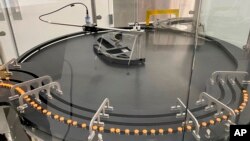 This picture provided by Pfizer in Oct. 2022 shows manufacturing of the company's COVID-19 bivalent vaccine for ages 5-11. The US on Oct. 12, authorized updated COVID-19 boosters for children as young as 5. (Pfizer via AP)