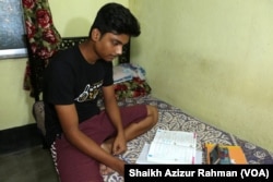 With his school closed because of a COVID lockdown, an Indian student, like hundreds of thousands of students across the country, studies online from home, using a mobile phone, last year.