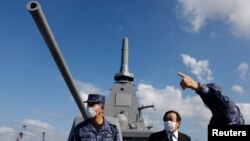 FILE - Japan's Defense Minister Yasukazu Hamada inspects the naval ship Mogami, featuring stealth capability, at the Japan Maritime Self-Defense Force naval base in Yokosuka, Kanagawa Prefecture, Japan, Sept. 5, 2022.
