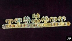 FILE - A 1,500 year-old golden tiara, inlaid with precious stones, one of the world's most valuable artifacts from the blood-letting rule of Attila the Hun, is seen in a museum in Melitopol, Ukraine, in November 2020.