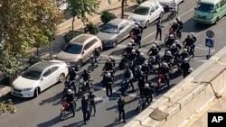 FILE - This frame grab from video taken by an individual not employed by the Associated Press and obtained by the AP outside Iran shows Iranian police dispersing a protest in Tehran, Iran, Oct. 26, 2022. Lawyers providing legal aid to protesters reportedly have been arrested.