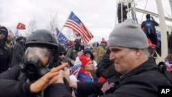 FILE - In this Jan. 6, 2021, image from video, Alan Byerly, right, is seen attacking an Associated Press photographer during a riot at the U.S. Capitol in Washington. 