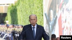 Lebanese outgoing President Michel addresses his supporters as he leaves the presidential palace a day before his six-year term officially ends, in Baabda, Lebanon, Oct. 30, 2022. 