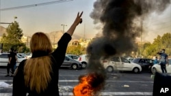 FILE - In this photo taken by an individual not employed by The Associated Press and obtained by the AP outside Iran, Iranians protests the death of Mahsa Amini after she was detained by morality police in Tehran, Oct. 1, 2022. The IRGC described media as “tools of the enemy.”