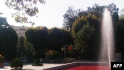 A man walk past the fountain of Park Daneshjoo, or Student Park, in the Iranian capital Tehran, reportedly colored red in protest against a deadly crackdown on three weeks of protests sparked by the death in custody of Mahsa Amini, in this UGC image made 