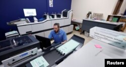 Sean Carney, a vote by mail assistant with the Leon County Supervisor of Elections office, prepares midterm elections ballots for mailing to voters in Tallahassee, Florida, Oct. 5, 2022.