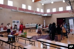 Residents attend an event hosted by Arizona State University graduate design students at Academia del Pueblo. (AP Photo/Matt York)