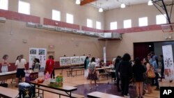 Residents attend an event hosted by Arizona State University graduate design students at Academia del Pueblo. (AP Photo/Matt York)