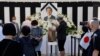 Mourners offer flowers at the altar outside Nippon Budokan Hall, which is hosting a state funeral for former Prime Minister Shinzo Abe in Tokyo, Sept. 27, 2022. 