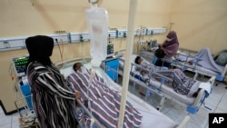 Relatives stand nearby as survivors of Saturday's soccer riots are treated at a hospital in Malang, East Java, Indonesia, Oct. 3, 2022.