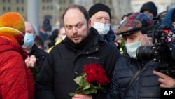 FILE - Vladimir Kara-Murza, Russian opposition activist, center, arrives to lay flowers near the place where opposition leader Boris Nemtsov was gunned down, in Moscow, Feb. 27, 2021. 